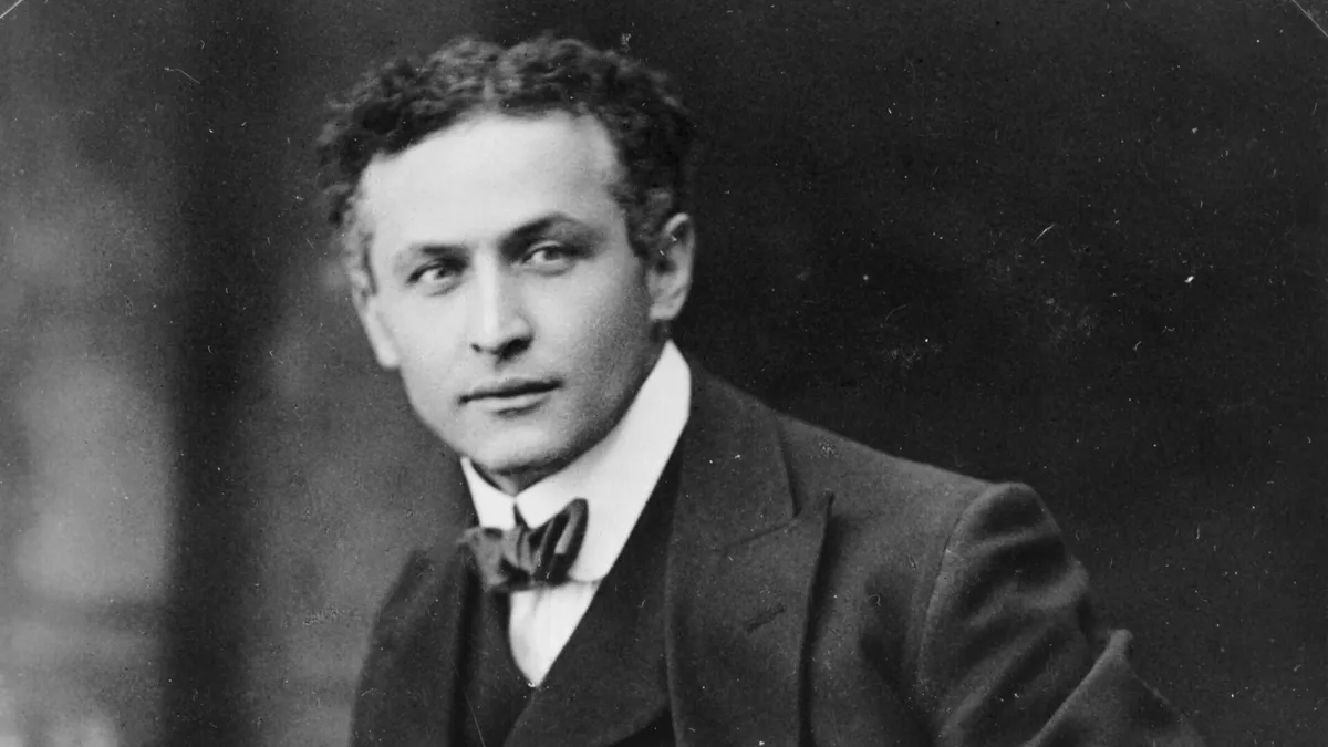 Black-and-white portrait of Harry Houdini in a dark suit and bow tie