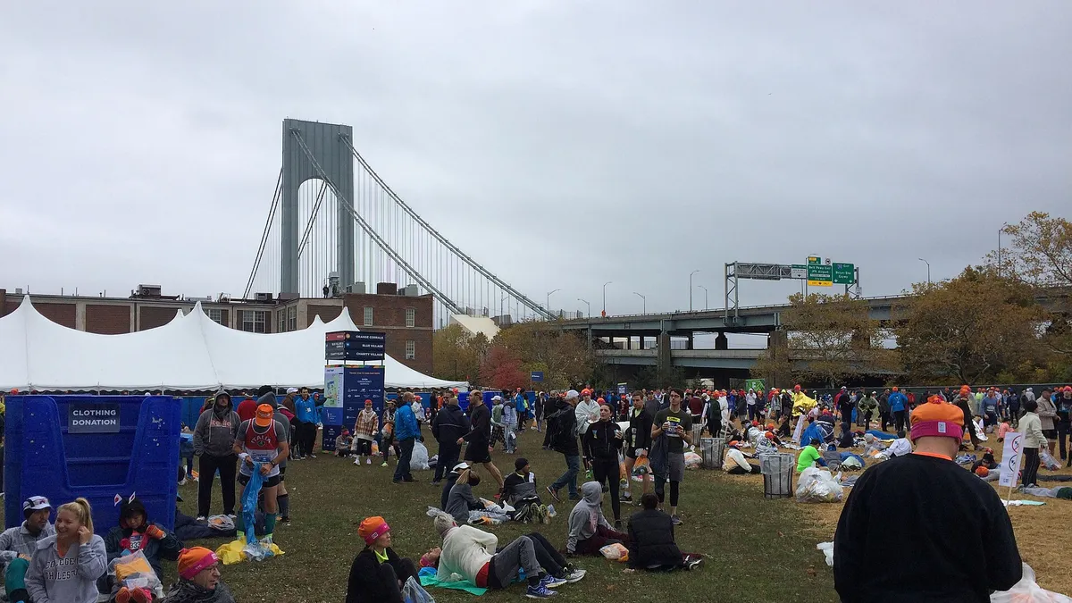 Runners waiting in the start village of the 2017 New York City Marathon below the Verrazzano-Narrows Bridge